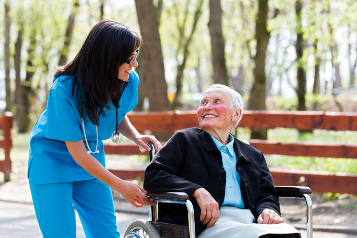 Kind Doctor Chatting With Elderly Lady